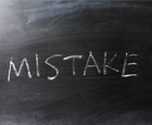 The word mistake is written on a blackboard in chalk